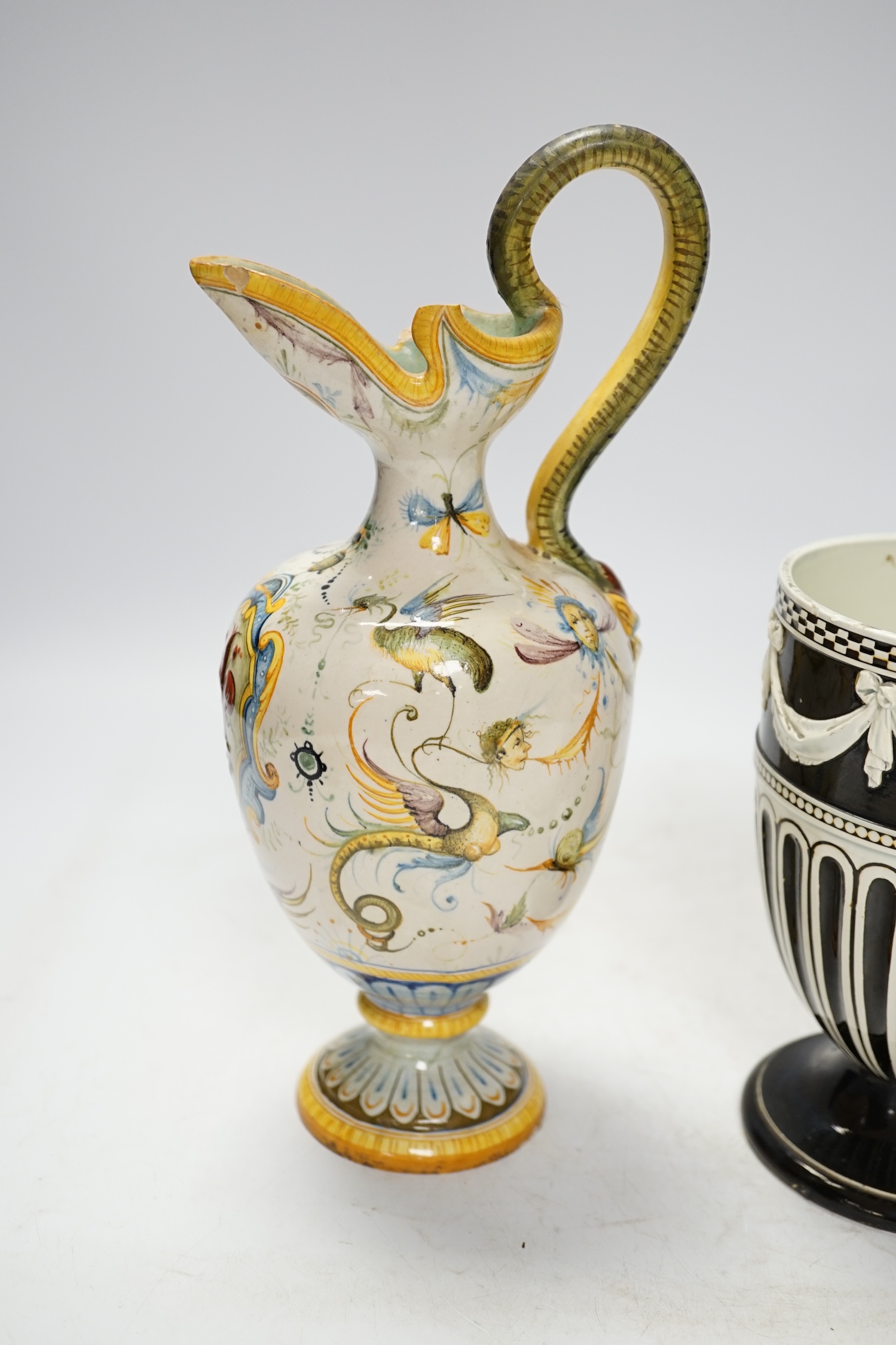 A Wedgwood pot and faience glazed jug and a Cantagalli maiolica pearl glazed jug, 26cm. Condition - poor, losses to upper rim of Cantagalli jug and restoration to base of Wedgwood
